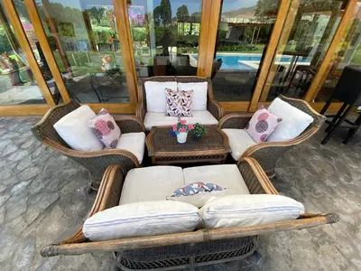 a group of wicker chairs with pillows on them at Casa de campo en Hacienda San Andres in San Andrés