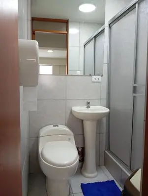 a bathroom with a toilet and a sink at La campiña in Lima