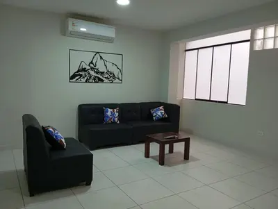 a living room with a couch and a coffee table at La campiña in Lima