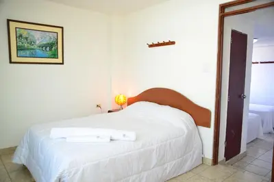 a bedroom with a white bed with two towels on it at Qallwa Asia in Asia