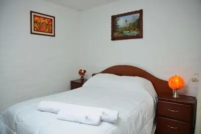 a bedroom with a white bed with two towels on it at Qallwa Asia in Asia