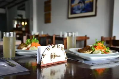 two plates of food on a table with plates of food at Qallwa Asia in Asia