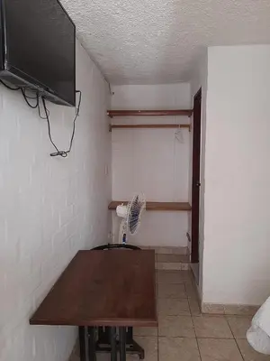 a room with a wooden table and a fan at Qallwa Asia in Asia