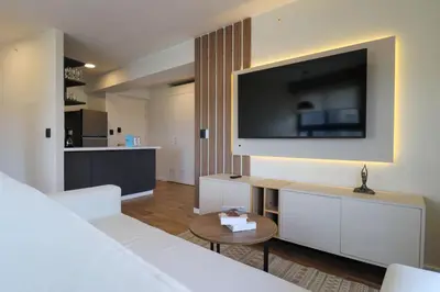 a living room with a bed and a flat screen tv at Moreyra by Wynwood House in Lima