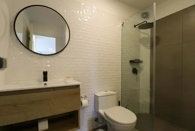 a bathroom with a toilet and a sink and a mirror at Moreyra by Wynwood House in Lima