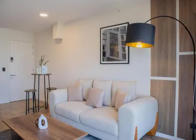a living room with a white couch and a table at Moreyra by Wynwood House in Lima