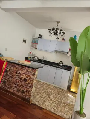 a kitchen with white cabinets and a brick counter top at Excelente Departamento las viñas in La Molina