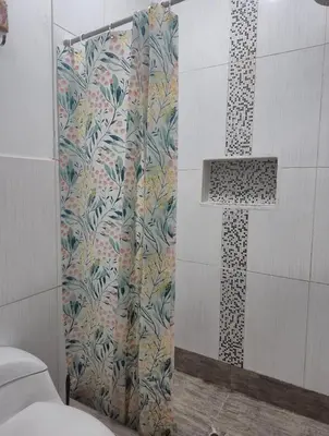 a shower curtain in a bathroom with a cross at Excelente Departamento las viñas in La Molina