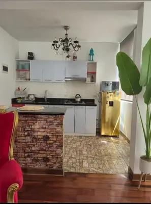 a kitchen with white cabinets and a gold refrigerator at Excelente Departamento las viñas in La Molina