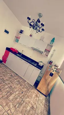 a kitchen with white cabinets and a counter top at Excelente Departamento las viñas in La Molina