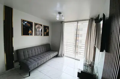 a living room with a couch and a window at Centrico departamento en Lima in Lima