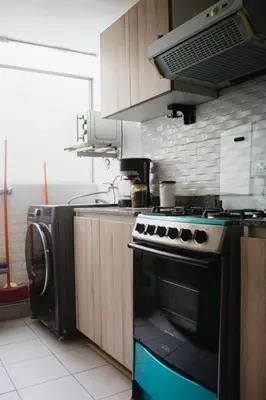 a kitchen with a stove and a dishwasher at Centrico departamento en Lima in Lima