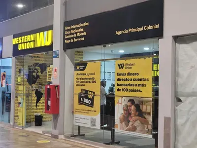 a store front with yellow signs in a building at Centrico departamento en Lima in Lima