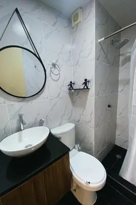 a bathroom with a toilet and a sink and a mirror at Centrico departamento en Lima in Lima