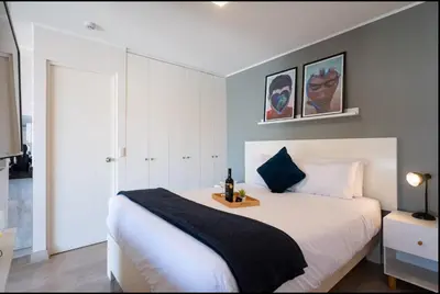 a bedroom with a large white bed with a black blanket at Stelar Apartments by Vibrant in Lima