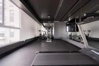 a gym with treadmills and machines in a building at Stelar Apartments by Vibrant in Lima
