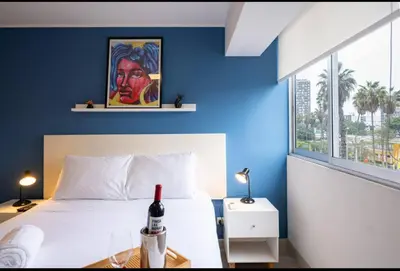 a bedroom with a bed with a bottle of wine on it at Stelar Apartments by Vibrant in Lima