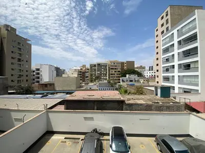 a parking lot with cars parked on the roof of a building at Nogales Family Apartments by Vibrant in Lima