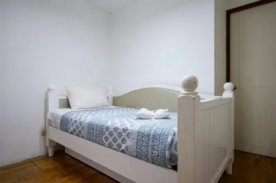a white bed with two towels on it in a bedroom at Nogales Family Apartments by Vibrant in Lima