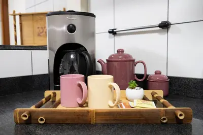 a wooden tray with mugs on a kitchen counter at Nogales Family Apartments by Vibrant in Lima