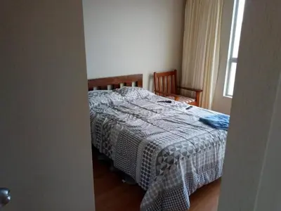 a bedroom with a bed with a blanket on it at Benito in Lima