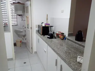 a kitchen with a counter with a microwave at Benito in Lima