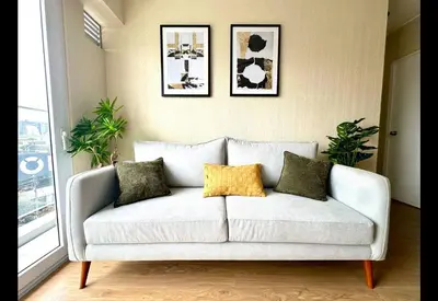a white couch with four pillows in a living room at Apartamento Céntrico cerca a San Isidro in Lima