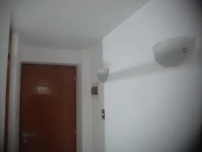a white room with a door and a white wall at Microdepartamento amoblado in Lima