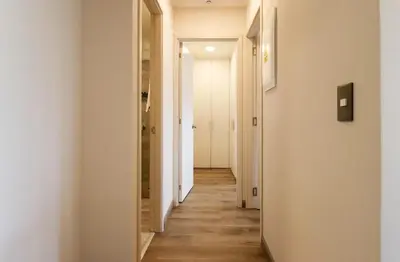 a hallway with white walls and wooden floors at Benavides by Wynwood House in Lima