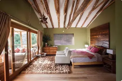 a bedroom with a bed and a couch in a room at SAMAY WASI Rest house in Ollantaytambo
