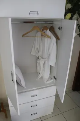 a white closet with white clothes in it at 102 habitacion con baño y cocina e ingreso independiente in Lima