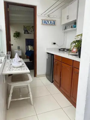 a kitchen with a table and a counter top at 102 habitacion con baño y cocina e ingreso independiente in Lima