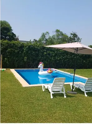 a pool with a rubber chicken in a inflatablelatablelatablelatable swimitating raft at Casa pachacamac in Pachacamac