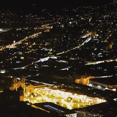 an aerial view of a city at night at The Tree House in Cusco
