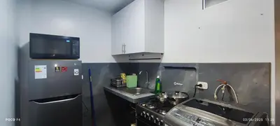 a small kitchen with a stove and a sink at Posada Estela in Lima