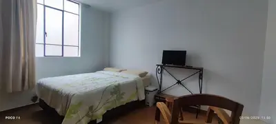 a bedroom with a bed and a chair and a window at Posada Estela in Lima