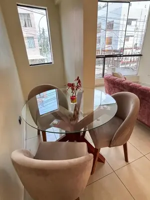 a glass table and chairs in a living room at Light department in Lima