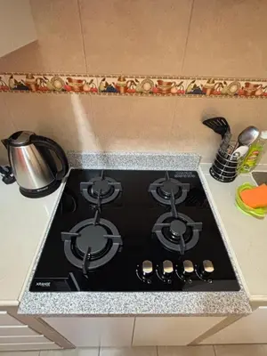a stove top oven with a pot on top of it at Light department in Lima