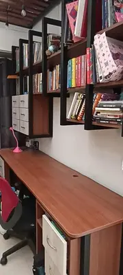 a desk with a book shelf with books at Depa4dormitoriosPuebloLibre in Lima