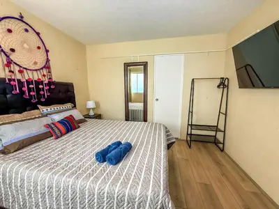 a bedroom with a bed with a blue object on it at Exclusivo con vista al mar - Blue One in Lima