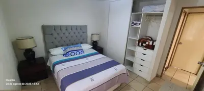 a small bedroom with a bed and a closet at Departamento Centenario in Lima