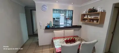 a kitchen with a table and two chairs and a clock at Departamento Centenario in Lima