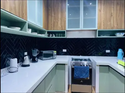 a kitchen with white counters and a stove top oven at Apartamentos como en casa in Chancay