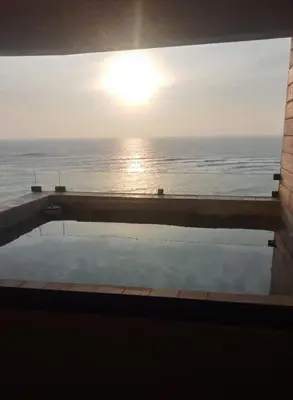 a swimming pool with a view of the ocean at Depa en Punta Hermosa in Punta Hermosa