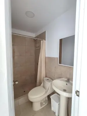 a bathroom with a toilet and a sink at Departamento de playa in Lima