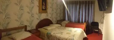 a hotel room with a bed and a bedroom with at La Casa de mi Abuelo in Cusco