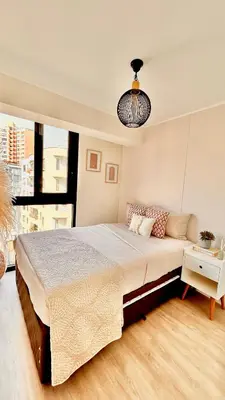 a bedroom with a large bed and a large window at Lima Limón in Lima