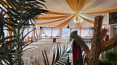 a banquet hall with white tables and chairs and a ceiling at Hotel Cusco Museo in Cusco