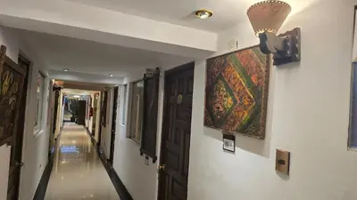 a hallway with a painting and a ceiling fan on a wall at Hotel Cusco Museo in Cusco