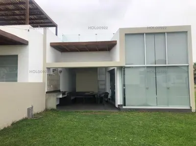 a house with glass doors and a green yard at Casa en Asia in Asia